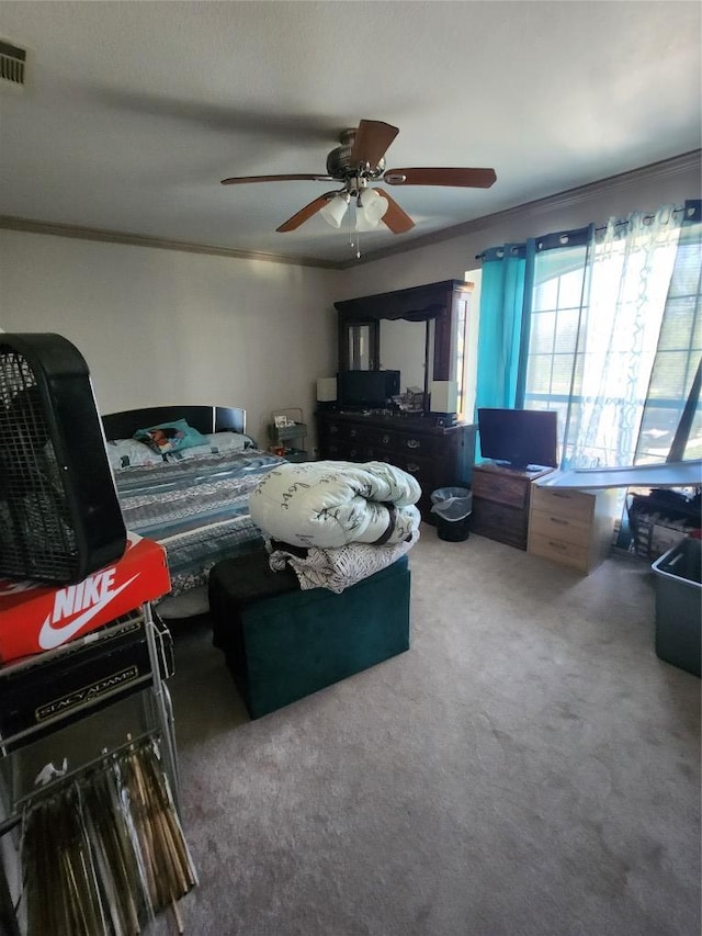 bedroom with carpet flooring, crown molding, visible vents, and ceiling fan