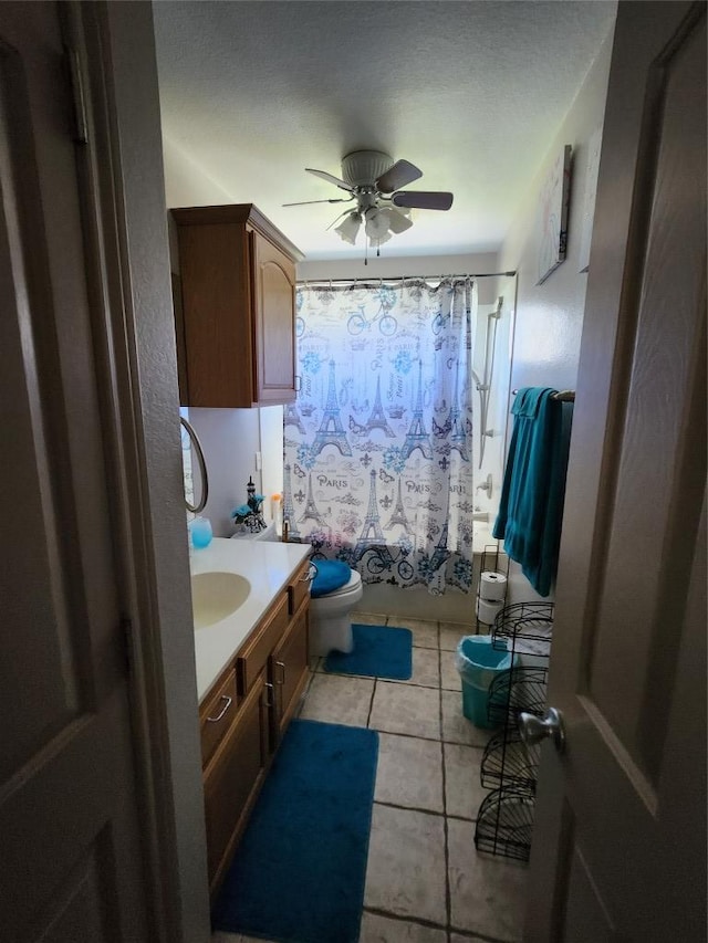 full bathroom featuring vanity, tile patterned flooring, shower / bath combination with curtain, toilet, and a ceiling fan