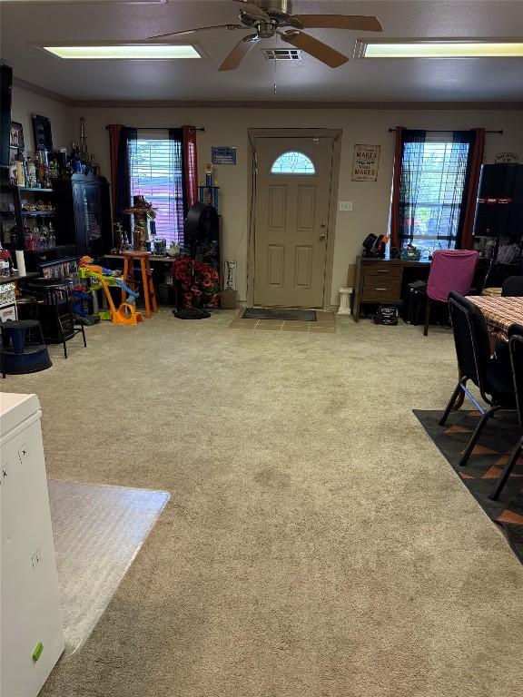 living area with carpet flooring and ceiling fan