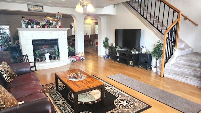 1149 State Highway 21 W Unit A, Cedar Creek, TX 78612 - living room with arched walkways, wood finished floors, stairs, ceiling fan, and crown molding