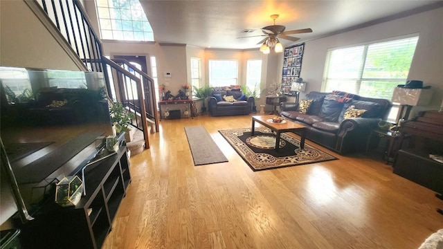 1149 State Highway 21 W Unit A, Cedar Creek, TX 78612 - living room featuring crown molding, a ceiling fan, wood finished floors, and stairway