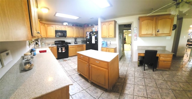 1149 State Highway 21 W Unit A, Cedar Creek, TX 78612 - kitchen featuring black appliances, light countertops, a kitchen island, and a sink