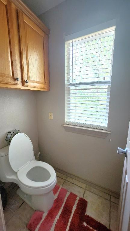1149 State Highway 21 W Unit A, Cedar Creek, TX 78612 - bathroom featuring toilet and tile patterned floors