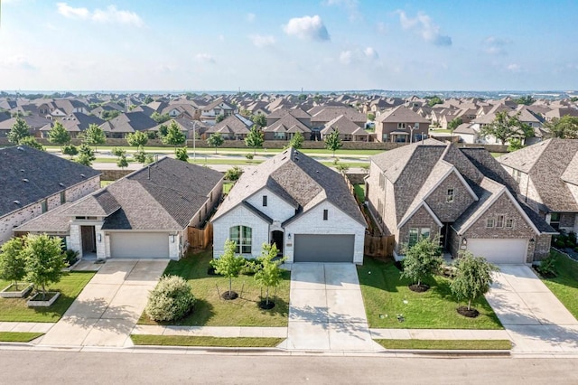 view of front facade with a residential view, driveway, and a front lawn