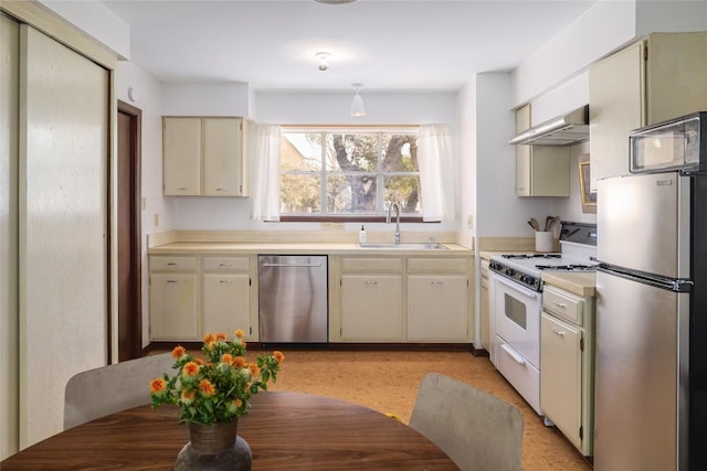305 Reimer Ave, San Marcos, TX 78666 - kitchen featuring stainless steel appliances, a sink, cream cabinets, light countertops, and exhaust hood