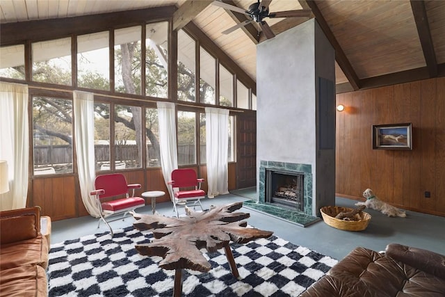305 Reimer Ave, San Marcos, TX 78666 - living area featuring healthy amount of natural light, wood ceiling with exposed beams, a fireplace, a ceiling fan, and wooden walls