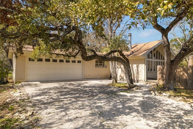 305 Reimer Ave, San Marcos, TX 78666 - view of front of property with brick siding, a garage, and driveway