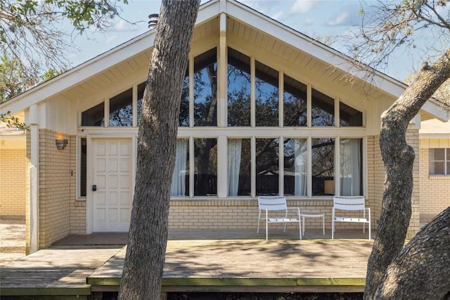 305 Reimer Ave, San Marcos, TX 78666 - back of property with brick siding and a wooden deck