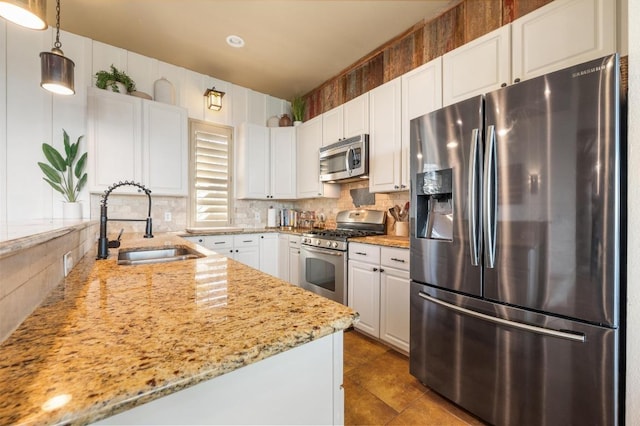 kitchen featuring white cabinetry, stainless steel appliances, and a sink
