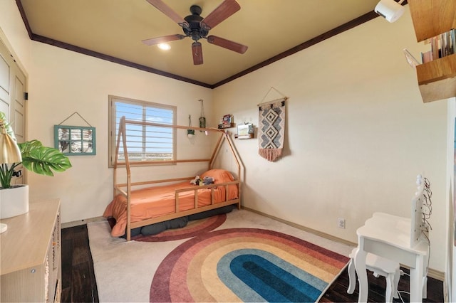 carpeted bedroom with crown molding, baseboards, and a ceiling fan