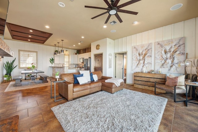 living area with a ceiling fan, recessed lighting, and visible vents