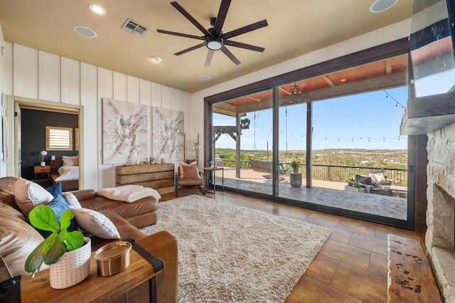 living area featuring a ceiling fan, recessed lighting, visible vents, tile patterned flooring, and a fireplace