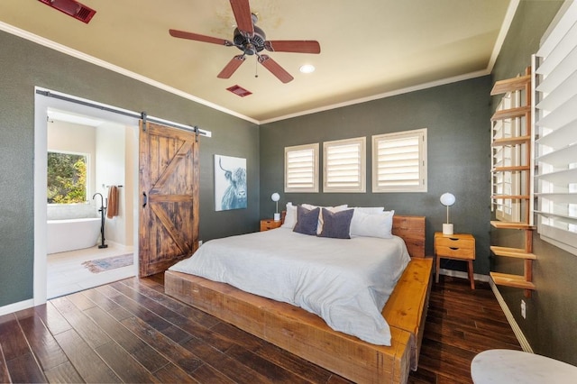 bedroom with recessed lighting, a barn door, baseboards, crown molding, and wood finished floors