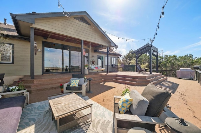 rear view of property with a wooden deck, a patio, and an outdoor living space