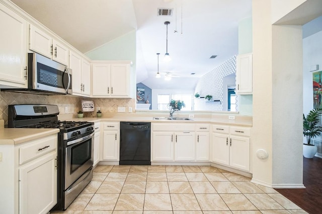 12316 Sugar Leaf Pl, Austin, TX 78748 - kitchen featuring appliances with stainless steel finishes, lofted ceiling, tasteful backsplash, light countertops, and white cabinetry