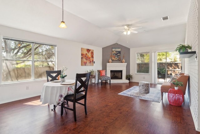 12316 Sugar Leaf Pl, Austin, TX 78748 - dining space featuring a ceiling fan, lofted ceiling, a brick fireplace, and wood finished floors