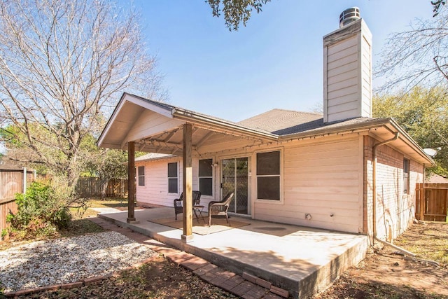 12316 Sugar Leaf Pl, Austin, TX 78748 - back of property with a chimney, a patio area, a fenced backyard, a shingled roof, and brick siding