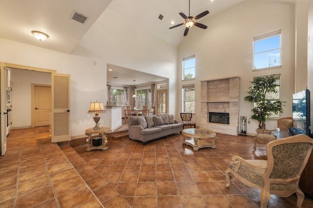 12029 Portobella Dr, Austin, TX 78732 - living room featuring high vaulted ceiling, ceiling fan, a fireplace, and baseboards