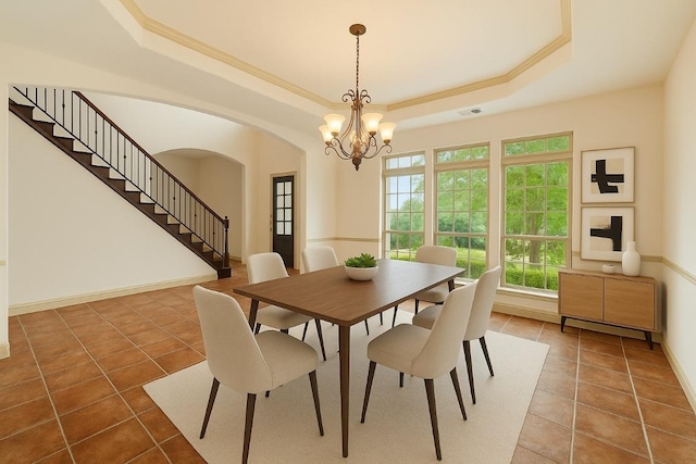 12029 Portobella Dr, Austin, TX 78732 - dining room featuring a raised ceiling, tile patterned flooring, arched walkways, a chandelier, and ornamental molding