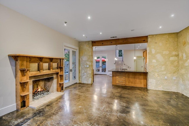 1701 Ravey St, Austin, TX 78704 - unfurnished living room with a lit fireplace, finished concrete flooring, and recessed lighting