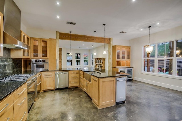 1701 Ravey St, Austin, TX 78704 - kitchen with stainless steel appliances, concrete floors, light brown cabinetry, healthy amount of natural light, and recessed lighting