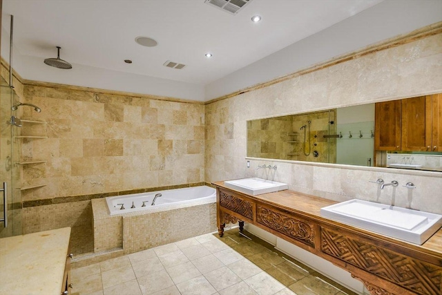 1701 Ravey St, Austin, TX 78704 - full bath featuring tile walls, a bath, a tile shower, double vanity, and tile patterned flooring