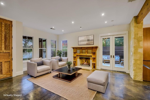 1701 Ravey St, Austin, TX 78704 - living room with french doors, recessed lighting, finished concrete flooring, and a lit fireplace