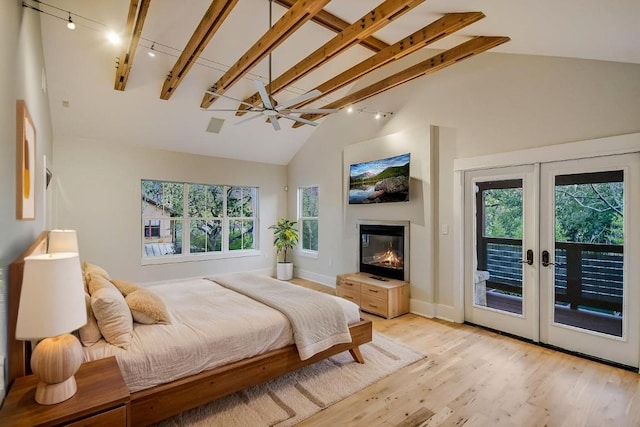 1701 Ravey St, Austin, TX 78704 - bedroom featuring track lighting, access to exterior, french doors, light wood finished floors, and high vaulted ceiling