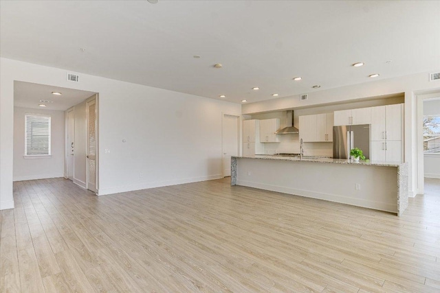 1715 Enfield Rd Unit 302, Austin, TX 78703 - unfurnished living room featuring light wood-style floors and recessed lighting
