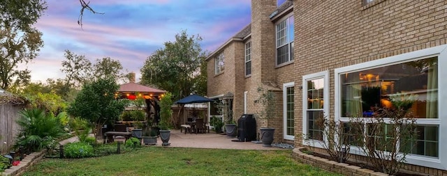 10105 Shinnecock Hills Dr, Austin, TX 78747 - yard at dusk featuring a gazebo, a patio area, and a lawn