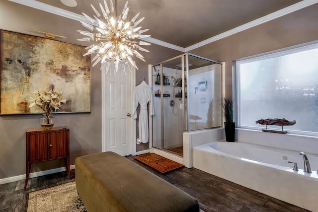 10105 Shinnecock Hills Dr, Austin, TX 78747 - bathroom featuring wood finished floors, a garden tub, a shower stall, crown molding, and a chandelier