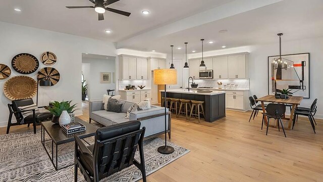 309 Golden Sage Ave, Georgetown, TX 78633 - living area featuring a ceiling fan, light wood finished floors, recessed lighting, and a chandelier