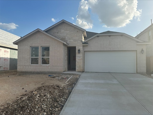 309 Golden Sage Ave, Georgetown, TX 78633 - view of front of home with an attached garage, driveway, and brick siding