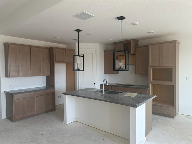 309 Golden Sage Ave, Georgetown, TX 78633 - kitchen with an island with sink, hanging light fixtures, recessed lighting, dark stone countertops, and black electric cooktop