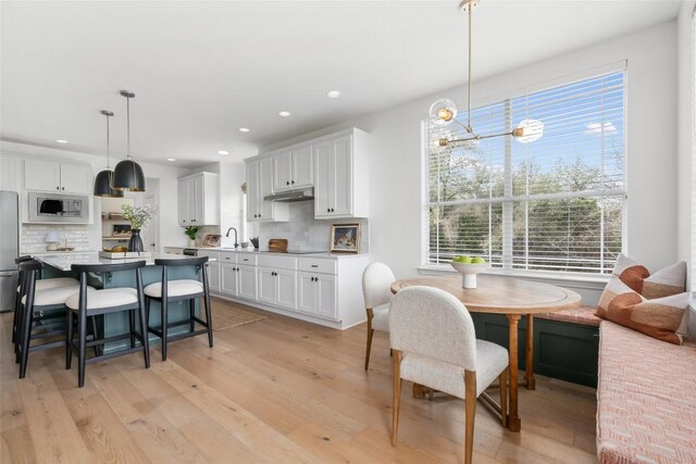 9943 Derecho Dr, Austin, TX 78737 - dining area with healthy amount of natural light, recessed lighting, and light wood-type flooring