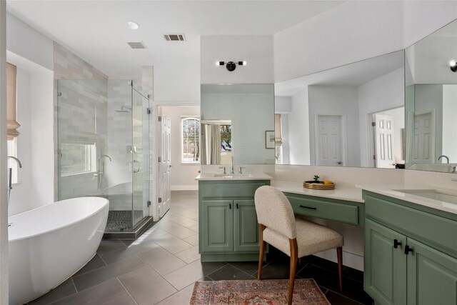 9943 Derecho Dr, Austin, TX 78737 - full bathroom with double vanity, a stall shower, a freestanding tub, and tile patterned floors