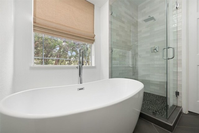 9943 Derecho Dr, Austin, TX 78737 - full bath featuring a shower stall, tile patterned flooring, a soaking tub, and a sink