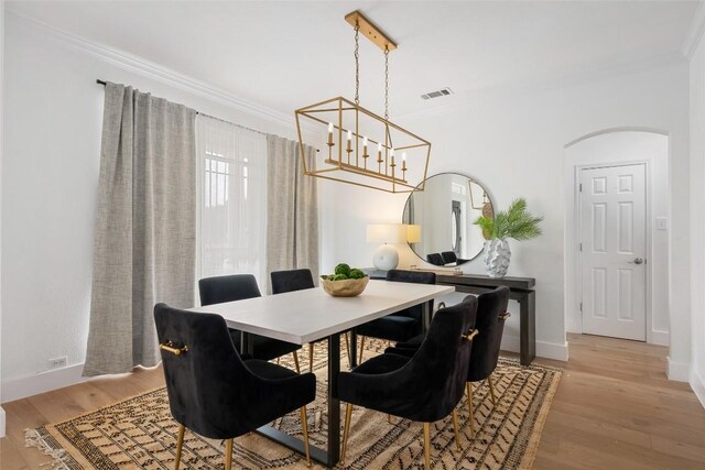 9943 Derecho Dr, Austin, TX 78737 - dining area with ornamental molding, a chandelier, light wood-type flooring, and baseboards