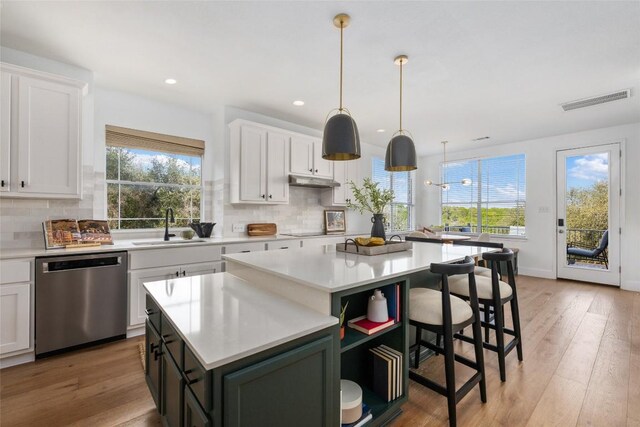 9943 Derecho Dr, Austin, TX 78737 - kitchen with dishwasher, a center island, white cabinetry, light countertops, and recessed lighting