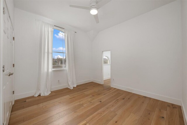 9943 Derecho Dr, Austin, TX 78737 - empty room featuring baseboards, light wood-style floors, a ceiling fan, and vaulted ceiling