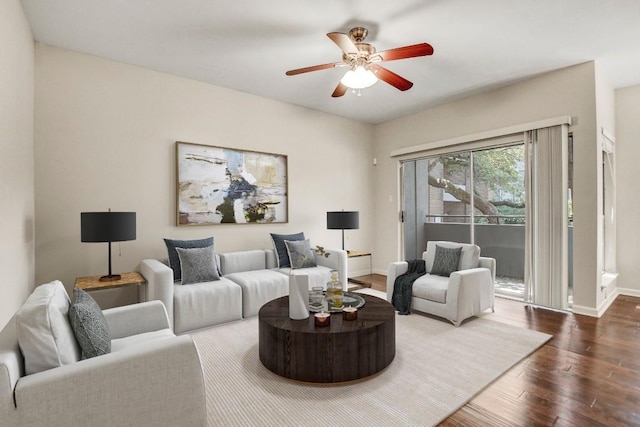 living area with dark wood finished floors, ceiling fan, and baseboards