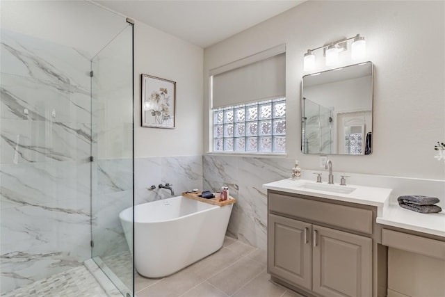 2535 Crenshaw Dr, Round Rock, TX 78664 - full bathroom with a freestanding tub, a marble finish shower, vanity, and tile walls