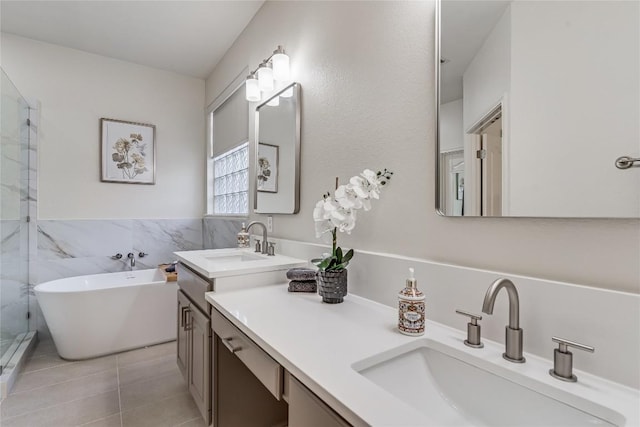 2535 Crenshaw Dr, Round Rock, TX 78664 - bathroom with a freestanding tub, a stall shower, vanity, tile patterned flooring, and tile walls