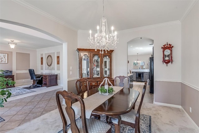 2535 Crenshaw Dr, Round Rock, TX 78664 - dining area featuring arched walkways, a chandelier, crown molding, baseboards, and light tile patterned floors