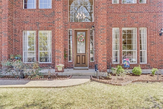 entrance to property featuring brick siding