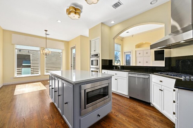 5903 Cane Pace, Austin, TX 78746 - kitchen with stainless steel appliances, wall chimney range hood, a sink, healthy amount of natural light, and recessed lighting