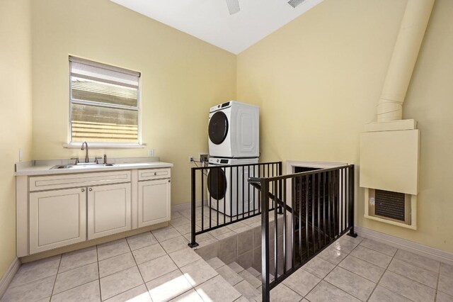 5903 Cane Pace, Austin, TX 78746 - laundry area with stacked washing machine and dryer, a sink, light tile patterned flooring, baseboards, and a ceiling fan
