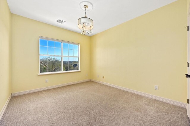 5903 Cane Pace, Austin, TX 78746 - unfurnished room featuring light carpet, baseboards, and a chandelier