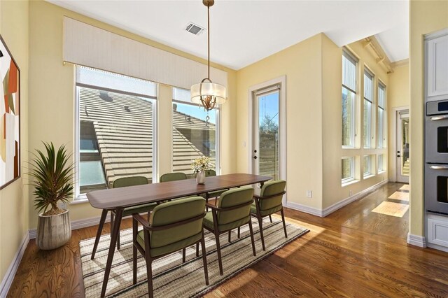 5903 Cane Pace, Austin, TX 78746 - dining area with plenty of natural light, baseboards, dark wood finished floors, and ornamental molding