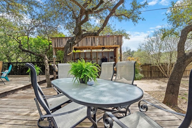 wooden deck with fence and outdoor dining area